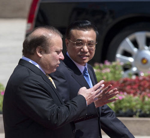 Pakistan Prime Minister Nawaz Sharif, left, walks with Chinese Premier Li Keqiang during a welcome ceremony held outside the Great Hall of the People in Beijing, China, Friday, July 5, 2013. Sharif is on an official visit to Beijing focused on courting Chinese investment in his country's ailing transport and electricity generating sectors. AP Photo