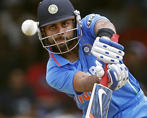 India acting captain Virat Kohli plays a shot on his way to score a century during the Tri-Nation Series cricket match against the West Indies in Port-of-Spain, Trinidad, Friday, July 5, 2013. (AP Photo/Andres Leighton)