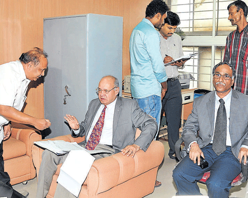Lokayukta Justice Y Bhaskar Rao inspects documents at the Karnataka Government Insurance Department in the City on  Friday. Lokayukta ADGP H N Sathyanarayan Rao is also seen.  DH Photo