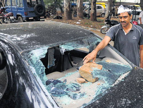 The damage: The car damaged during the clash in Islampura on Friday. (R) Home Minister K&#8200;J George visits the injured at a hospital. DH Photos