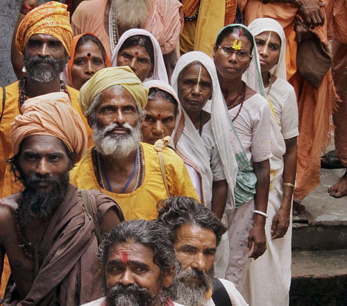Sadhus stand in a queue to register for the annual pilgrimage to the Amarnath cave shrine in Jammu .PTI Photo
