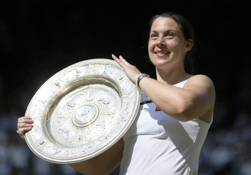 Marion Bartoli of France holds her winners trophy, the Venus Rosewater Dish, after defeating Sabine Lisicki of Germany in their women's singles final tennis match at the Wimbledon Tennis Championships, in London Reuters Image