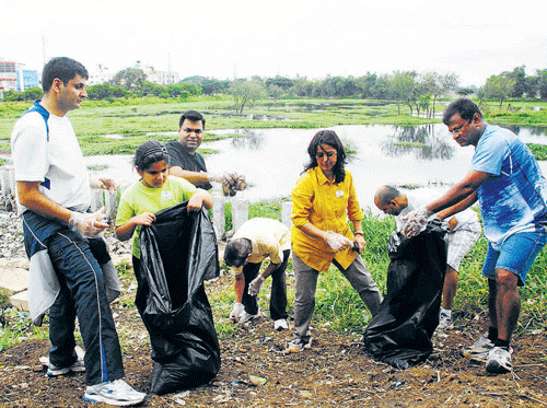 for the common good Residents of HSR Layout clear  waste from Agara Lake during the 'Save Agara Lake'  campaign on Sunday. kpn