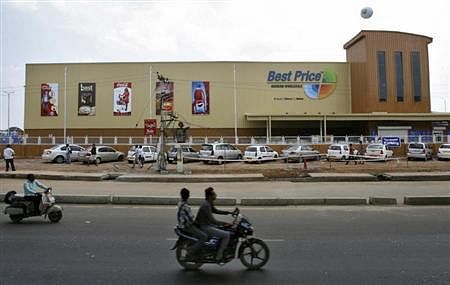 Two-wheelers move past the newly opened Bharti Wal-Mart Best Price Modern wholesale store in the southern Indian city of Hyderabad, September 26, 2012. REUTERS