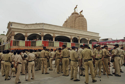Police men and women wait deployment outside Lord Jagannath temple for annual Rath Yatra or Chariot procession in Ahmadabad, India, Sunday, July 7, 2013. Security has been beefed up for the annual Hindu procession to be held on July 10 in which the three idols of Hindu God Jagannath, his brother Balabhadra and sister Subhadra are taken out in a grand procession in specially made chariots called raths, which are pulled by thousands of devotees during the Rath Yatra or the chariot festival. (AP Photo)