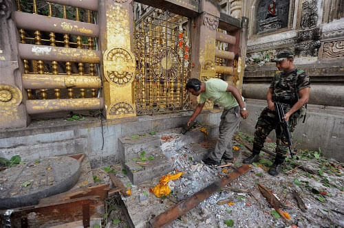 Security personnel inspecting the explosion site after a serial blast in Mahabodhi temple complex at Bodhgaya on Sunday. PTI photo