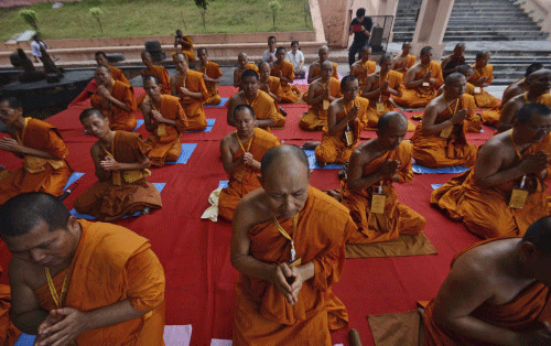 Buddhist monks from Thailand offer prayers at the Mahabodhi or the Great Awakening Temple, in Bodh Gaya, India, Monday, July 8, 2013. Two people were wounded in the eight blasts that went off Sunday in and around the main temple complex in Bodh Gaya, the town where the Buddha is believed to have gained enlightenment. AP Photo