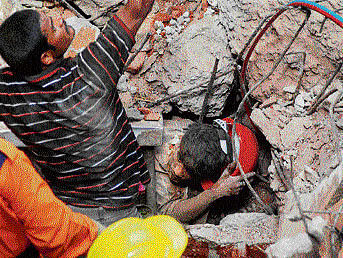 Rescue workers try to save an injured person after a  hotel collapsed in Secunderabad. PTI