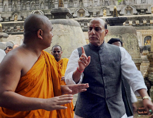 BJP President Rajnath Singh interact with the chief priest during his visit to the Mahabodhi Temple at Bodhgaya on Tuesday, two days after the series of blast. PTI Photo