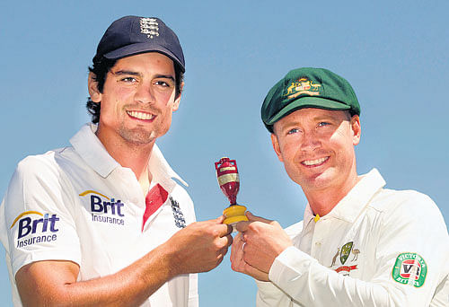Little big trophy: England captain Alastair Cook (left) and his Australian counterpart Michael Clarke pose with a replica  of the Ashes urn at Nottingham on Tuesday. Reuters