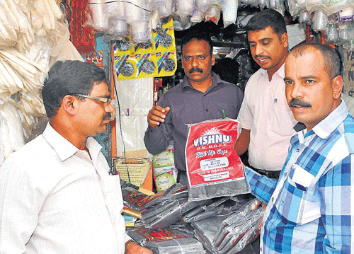 Surprise raid: Mysore City Corporation health officials led by MCC Health Officer Dr D G Nagaraj, raided wholesale plastic stores in the city, on Wednesday. dh photo