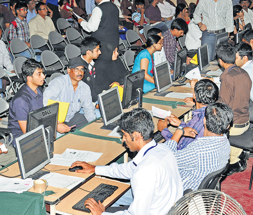 Students and parents at the Comed-K engineering counselling at NMKRV College in  Bangalore on Wednesday. dh photo