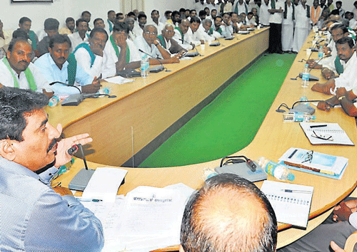 A farmer makes a point to Deputy Commissioner Ramegowda at the meeting in Mysore on Thursday. dh photo