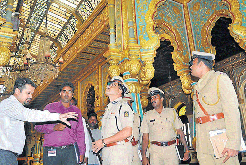 Police Commissioner M A Saleem looks at a CCTV camera installed in the Palace as a representative of a private firm explains about its functioning, in Mysore on Thursday. dh photo