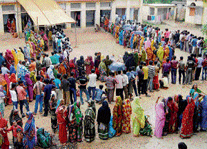 Women stand in a queue to cast their votes at a polling station in the Bankura district of West Bengal on Thursday. PTI