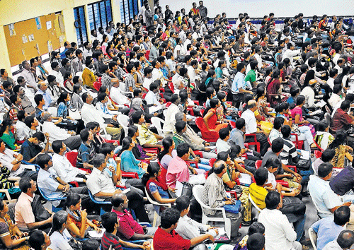 RAPT audience: Parents and students at KEA listen to instructions on paying admission  fee, during the first session of CET in Bangalore on Thursday. dh photo