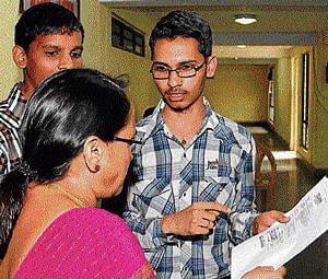 A student seeks clarification on the admission process from a KEA official in Bangalore on Friday. dh photo