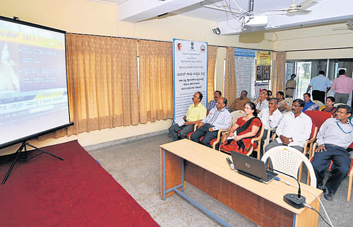 in anticipation: Members of Mysore Industries Association watch Budget presentation on a giant screen at their office, on KRS Road in Mysore, on Friday. DH Photo