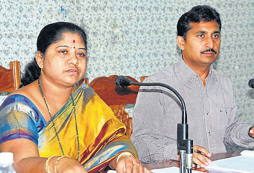 ZP chief Ambika Ramakrishna speaks at the progress review meeting at Hoysala auditorium in Hassan. dh photo