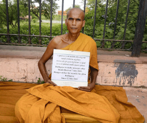 A Buddhist monk sitting on hunger strike outside the Mahabodhi temple demanding security for the blast-hit temple at Bodhgaya on Friday. PTI Photo