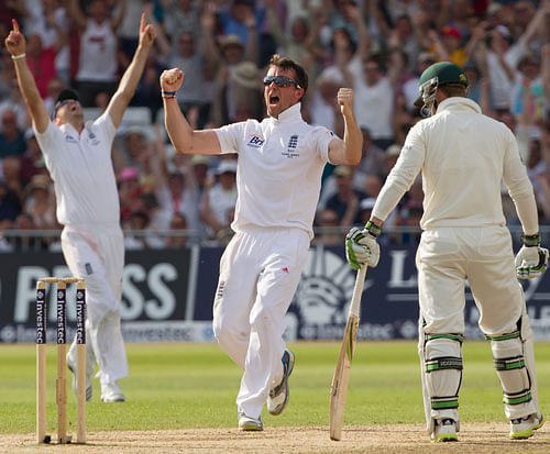 England's Graeme Swann, centre, celebrates after taking the wicket of Australia's Steve Smith, LBW for 17 on the fourth day of the opening Ashes series cricket match at Trent Bridge cricket ground, Nottingham, England, Saturday, July 13, 2013. AP Photo