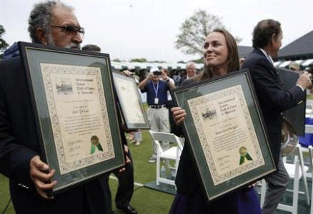Tennis Hall of Fame inductees Ion Tiriac, Martina Hingis and Cliff Drysdale parade with their plaques following the Tennis Hall of Fame induction ceremony in Newport, Rhode Island July 13, 2013. Credit: REUTERS/