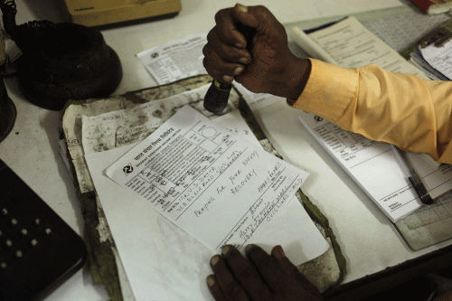 A telegraph employee processes a telegram on the last day of the 163-year-old service, in Allahabad, Sunday, July 14, 2013. Sunday night, the state-run telecommunications company will send its final telegram, closing down a service that fast became a relic in an age of email, reliable landlines and ubiquitous cellphones. AP Photo