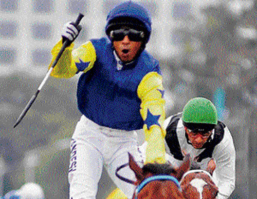 WINNING MOMENTS: Jockey A Sandesh celebrates after guiding Alaindair to victory in the Bangalore Derby at the BTC on Sunday.