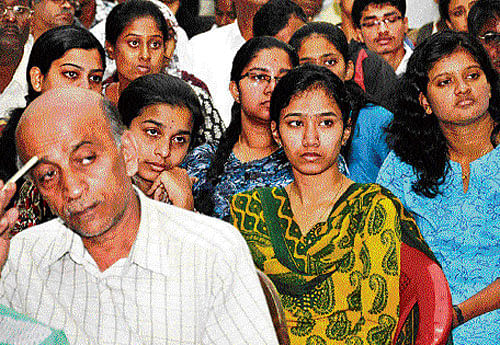 Students and parents anxiously wait for their turn at the KEA office in Bangalore. DH Photo