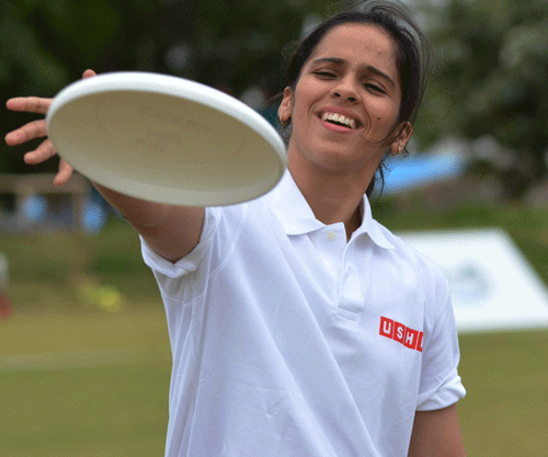 Olympic bronze medal winner badminton player Saina Nehwal plays a frisbee game during an event at out skirts of Bengaluru on Sunday. PTI Photo