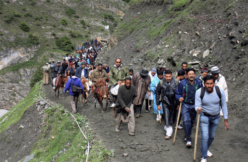 Hindu pilgrims trekking their route to Amarnath shrine near Dhumail in Sonamarg on Friday. PTI Photo