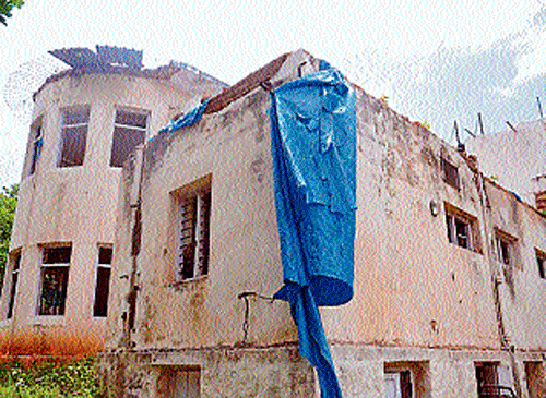 A view of the half demolished bungalow belonging to noted author R K Narayan at Yadavagiri, in Mysore.   dh photo