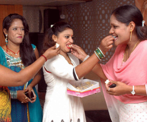 Bar girls celebrate with sweets the Supreme Court's ruling on dance bars in Mumbai on Tuesday. PTI Photo