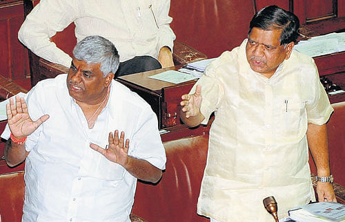 Helping hand: JD(S) legislator H D Revanna comes to the rescue of BJP&#8200;floor leader  Jagadish Shettar during discussions on the budget proposals in the Assembly on Tuesday. dh photo