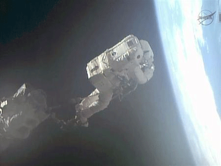 Flight engineer Luca Parmitano rides the Canadarm2 to an International Space Station worksite during a July 9, 2013 Expedition 36 spacewalk in this still handout image taken from NASA TV footage.  Credit: Reuters