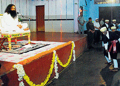 Gurmeeth Ram Rahim Singh, head of India-based socio-spiritual organisation Dera Sacha Sauda viewing Kodava traditional dance Kolata, at Kaveri hall in Madikeri, on Wednesday.