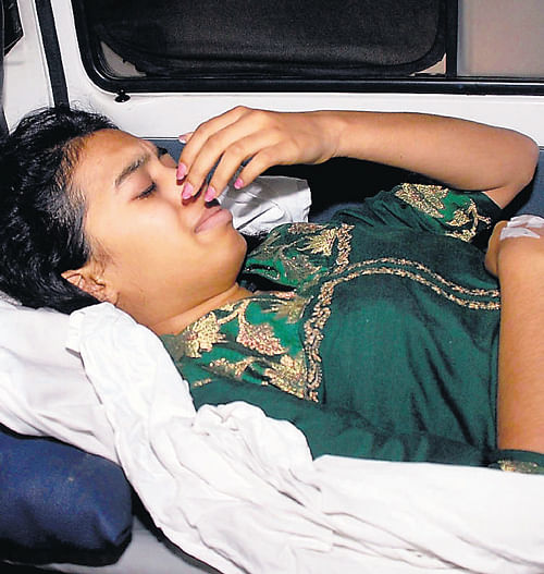 bolt from the blue: Ragi, one of the students of Mount Carmel PU College, who were injured in the accident, being shifted to hospital on Wednesday. DH Photos