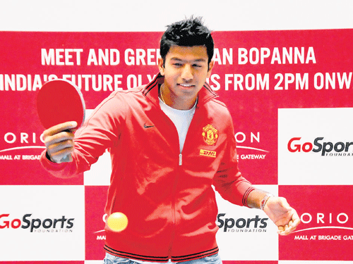 red-hot: Doubles tennis ace Rohan Bopanna tries his hand at table tennis during a promotional event. DH photo
