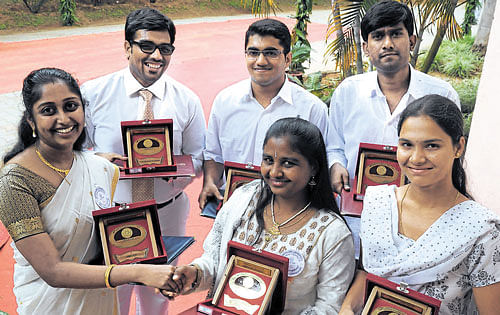 bright brains: Gold medal winners greet each other at the annual convocation of Bangalore University on Thursday. DH Photo