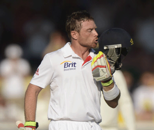 England's Ian Bell celebrates by kissing the badge on his helmet after reaching his century during the second Ashes cricket test match against Australia at Lord's cricket ground in London July 18, 2013. REUTERS