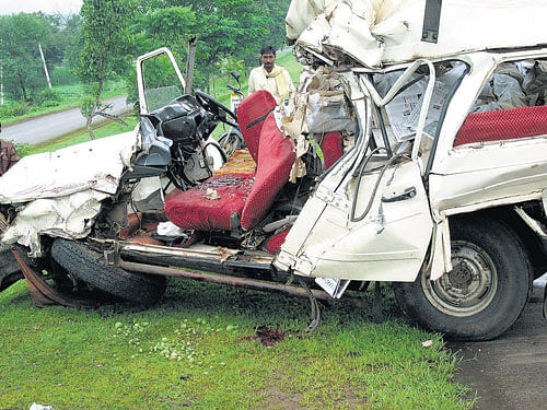 fatal impact: The mangled remains of the Tempo Trax which struck a parked lorry near Solapur Cross on the  Pune-Bangalore highway on Thursday. dh photo