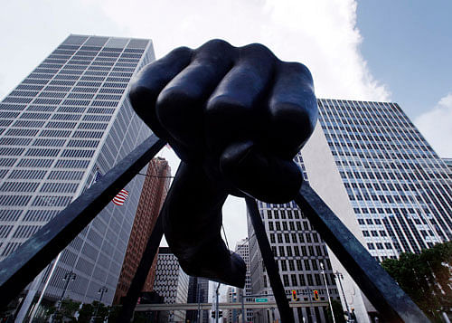 The Detroit skyline rises behind the Monument to Joe Louis, also known as 'The Fist,' Thursday, July 18, 2013. State-appointed emergency manager Kevyn Orr asked a federal judge permission to place Detroit into Chapter 9 bankruptcy protection. (AP Photo