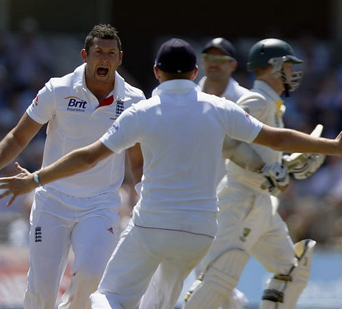 England's bowler Tim Bresnan, left, celebrates lbw of Australia's Shane Watson with teammate during day 2 of the second Ashes Test at Lord's cricket ground in London, Friday, July 19, 2013. (AP Photo/Sang Tan)