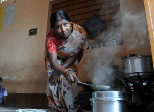A cook prepares food to serve to children as part of Governments mid-day meal scheme at one of the Anganwadi center on Modi Road, Indrapuram, D J Halli in Bangalore on Friday.  DH Photo