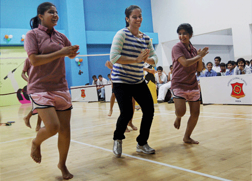 Olympic bronze medal winner badminton player Saina Nehwal trains with school children at the launch of the Indian Badminton League's School Programme initiative 'Shuttle Express' at Noida on Friday. PTI Photo