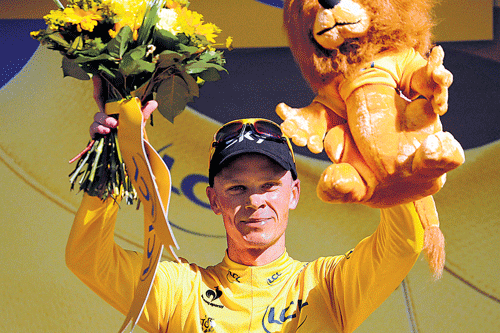 picture of delight: Briton Chris Froome celebrates with the yellow jersey at the end of the 20th stage on Saturday. AFP
