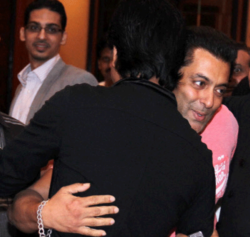 Actor Salman Khan hugs Shahrukh Khan during an Iftaar party in Mumbai on Sunday. PTI Photo