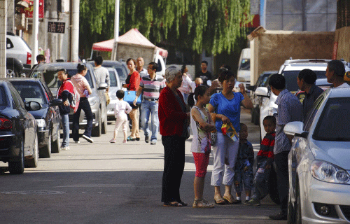 People stand outside their homes after a 6.6 magnitude earthquake hit Dingxi, Gansu province, July 22, 2013. The earthquake in China's western Gansu province killed 11 people and seriously injured another 81, state media said on Monday. REUTERS