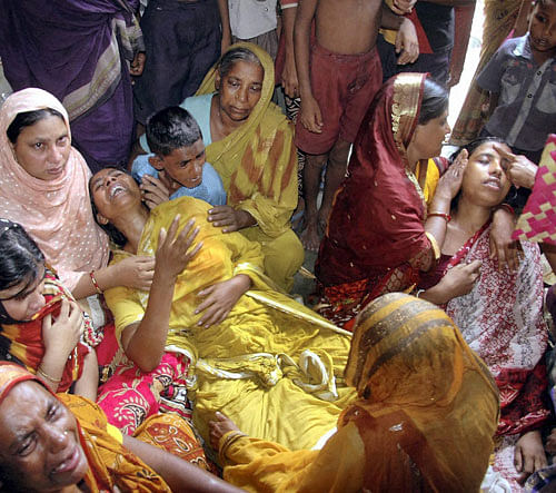 Murshidabad: Family members of the Congress activists who were killed at a political class ahead of the 4th phase of West Bengal Panchayat polls, in Murshidabad on Sunday.PTI Phot