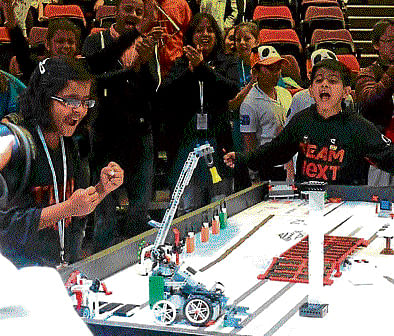 global win Team NeXT cheer their robots